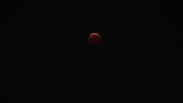 FUKUOKA, JAPAN - 8 NOVEMBER 2022 : A total lunar eclipse coinciding with a lunar occultation of Uranus, in which the planet is eclipsed by the moon. Such an occurrence hadn&rsquo;t been seen in 442 years.