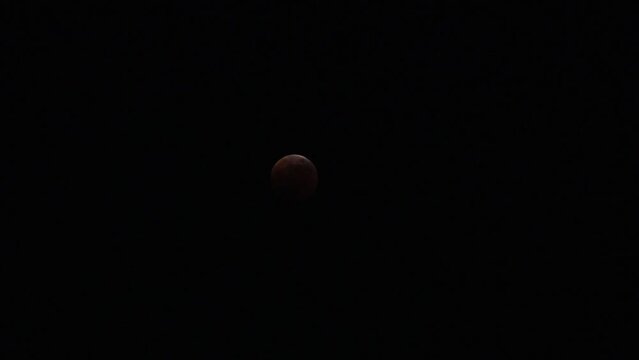 FUKUOKA, JAPAN - 8 NOVEMBER 2022 : A total lunar eclipse coinciding with a lunar occultation of Uranus, in which the planet is eclipsed by the moon. Such an occurrence hadn&rsquo;t been seen in 442 years.