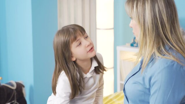 The mother has reassuring conversations and they maintain good relations with her little daughter. Happy family concept.