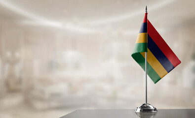 A small Mauritius flag on an abstract blurry background