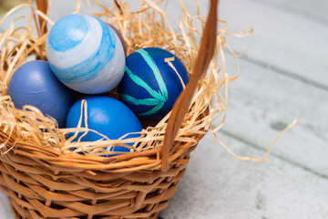 Painted blue easter eggs in a basket