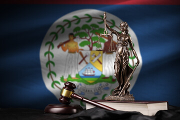 Belize flag with statue of lady justice, constitution and judge hammer on black drapery. Concept of...