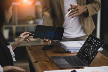 Technology and financial advisory services concert. Business teamwork and working on digital laptop computer with advisor showing plan of investment to clients at table office. Digital marketing.