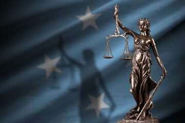 Micronesia flag with statue of lady justice and judicial scales in dark room. Concept of judgement...
