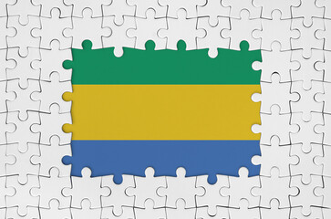 Gabon flag in frame of white puzzle pieces with missing central parts