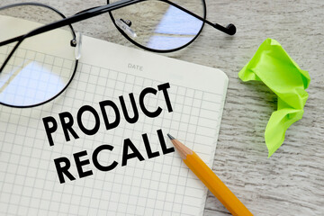 Product Recall . text on a notebook near glasses.