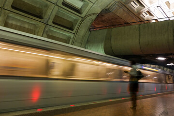 Washington D.C. - Subway station with passengers and train in motion blur	