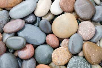 Fototapeta na wymiar Smooth round wet pebbles texture background. Pebble sea beach close-up