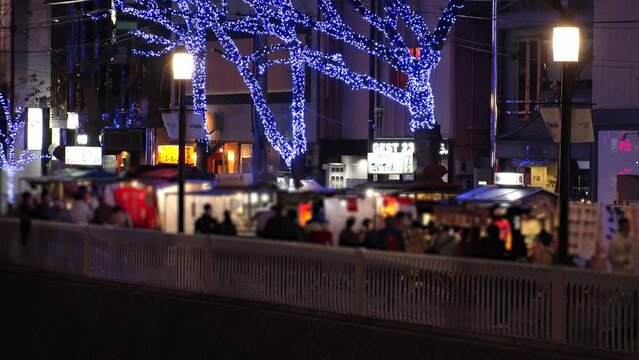 NAKASU, HAKATA, FUKUOKA, JAPAN - NOVEMBER 2022 : View of STREET FOOD STALLS (Yatai) in Nakasu area at night. Open air food stands are the Fukuoka city's famous symbol.