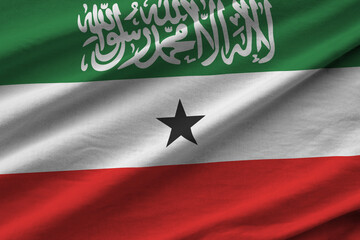 Somaliland flag with big folds waving close up under the studio light indoors. The official symbols...