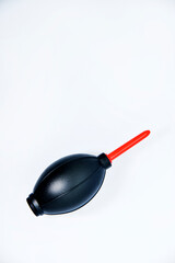 Tools for cleaning photo optics. Pneumatic pear brush on a white background. Camera cleaning kit.