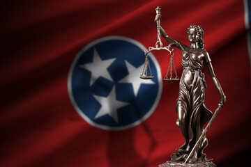 Tennessee US state flag with statue of lady justice and judicial scales in dark room. Concept of...