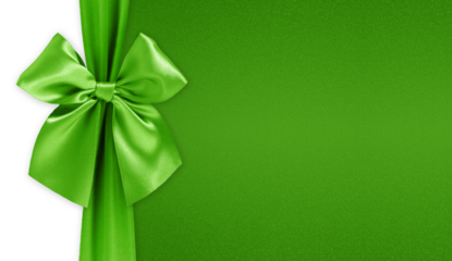 Green bright ribbon bow isolated on glitter background, top view copy space for gift greeting card, Merry Christmas, St Patrick or father day banner or valentine present