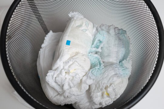Used diapers in bin, top view. Concept care of baby health, hygienic, ecology.