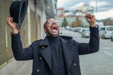 euphoric man excited with joy in the street