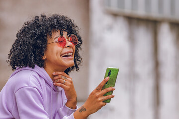 afro girl with sunglasses and mobile phone