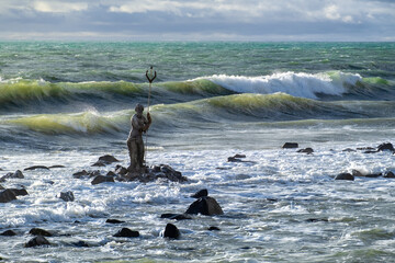 Statue of Neptune by  an unknown author in the sea against the waves, view from the the pier....