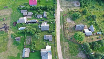 Aerial view of a typical modern European village in summer. Russian huts, wooden houses, rural...