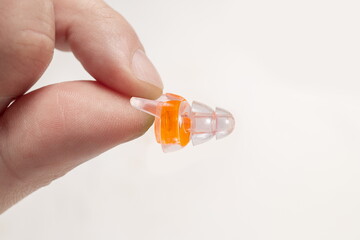 Human silicone earplugs hold fingers on white background