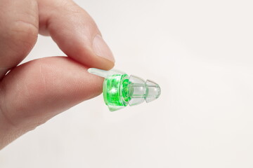 Human silicone earplugs hold fingers on white background