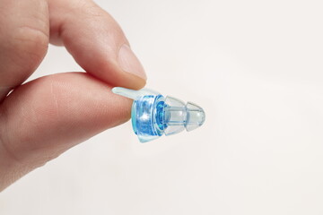 Human silicone earplugs hold fingers on white background