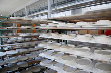 Authentic porcelain production in the Porcelain Manufactory Meissen - white plates before firing...