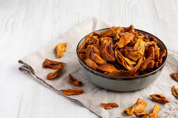 Delicious Organic Dried Mango Fruit in a Bowl, low angle view. Space for text.