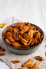 Delicious Organic Dried Mango Fruit in a Bowl, low angle view. Copy space.