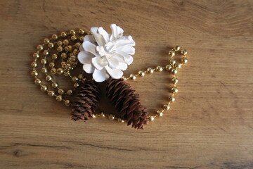 Mandarin slices on a wooden table with a green leaf and gold beads