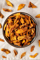 Delicious Organic Dried Mango Fruit in a Bowl, top view. Flat lay, overhead, from above.