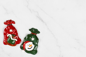 Christmas sweets covered with colored icing sugar in the shape of two Santa Claus bags with gifts. White background. Copy space