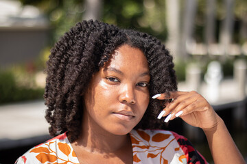 Natural Black Woman basking in the sun enjoying the water.