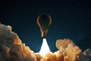 Creative rocket light bulb with smoke and blast successfully takes off into the starry sky. Business start up launch and successful idea, concept. - obrazy, fototapety, plakaty