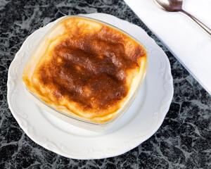 Baked rice pudding Turkish milky dessert sutlac in an earthenware casserole.
