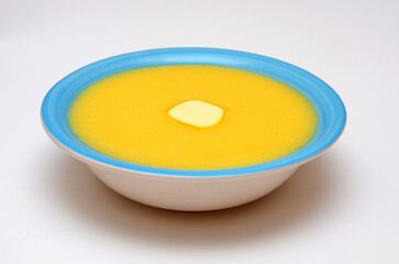 corn porridge in a bowl on a white background close-up