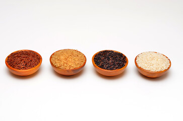 different types of dry rice in bowls on a white background