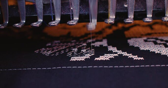 Embroidery machine in progress embroidery Ukrainian national traditional pattern. company logo on uniform in Textile Industry Garment Manufacturers. automatic embroidery machine is working high speed