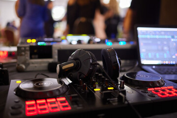 Fototapeta na wymiar DJ console cd mp4 deejay mixing desk Ibiza house techno dance music wedding reception party in nightclub with colored lighting effect disco lights.