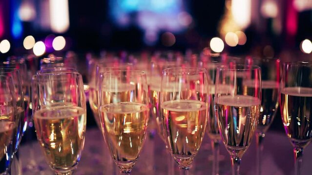 Many champagne glasses: New Year's party event is decorated with colorful lightening