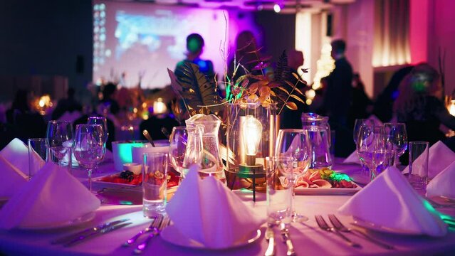 New Year's party event is decorated with beautiful details at tables and colorful lightening
