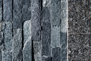 Granite stone and sandstone stones on the wall of a modern house, beautiful stone and granite texture, close up