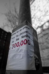 a poster about Nanjing Massacre on a telegraph pole in Manchester