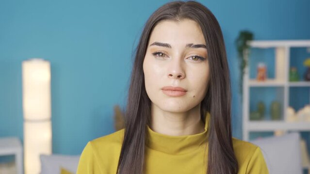 Desperate and depressed woman sad.
Sad young woman feeling unwell looking at camera, domestic violence, divorce, harassment, slander.
