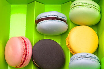  a colorful macaroons in a green box
