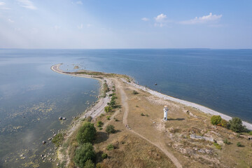 Small, old lighthouse on a beach by the Baltic Sea in Estonia