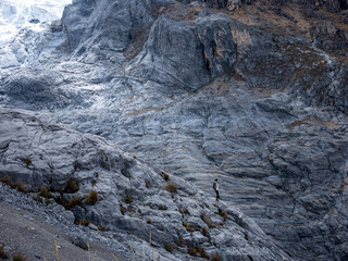 Man on the rocks near al nevado, in the mountains of Peru South America