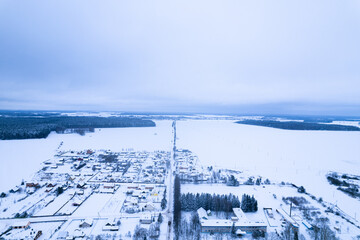 Fototapeta na wymiar Top view of the winter panorama of the Vileysky reservoir and the village