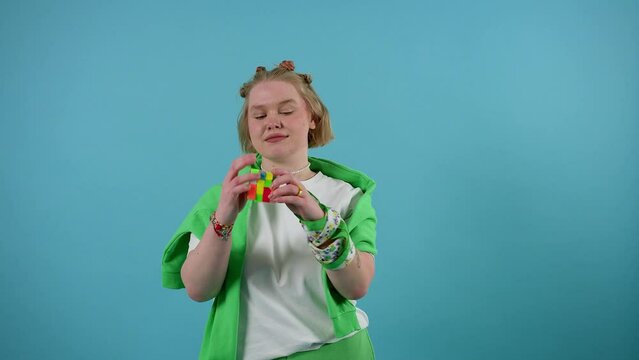 Cute European girl playing with Rubik's Cube