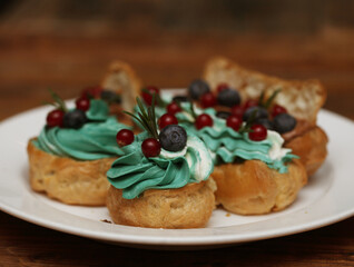 cakes on a plate - cupcakes and eclairs