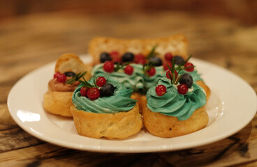 cakes on a plate - cupcakes and eclairs